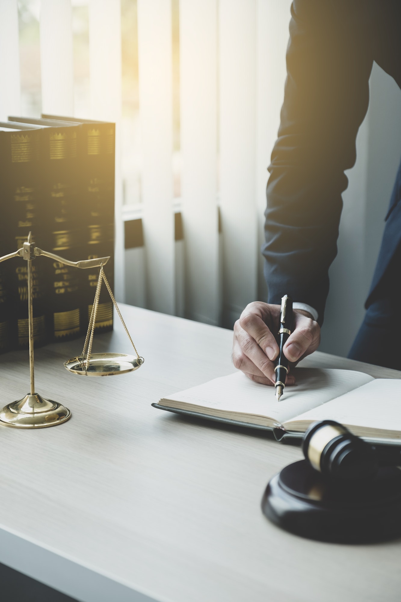 Lawyer hand holding pen and providing legal consult business dispute service at the office