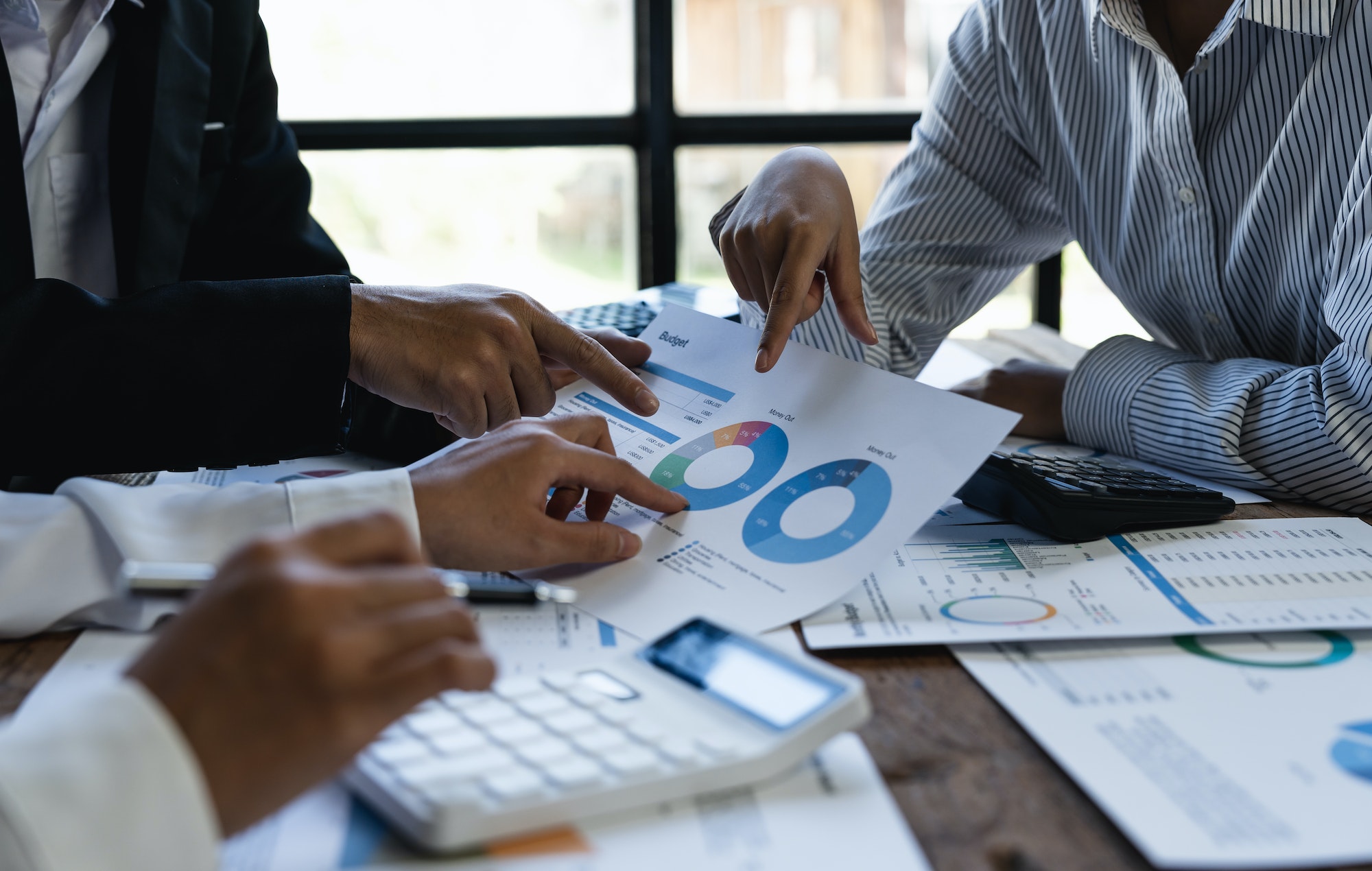 Marketing, Financial, Accounting, Planning, business team use calculators and graph analysis to